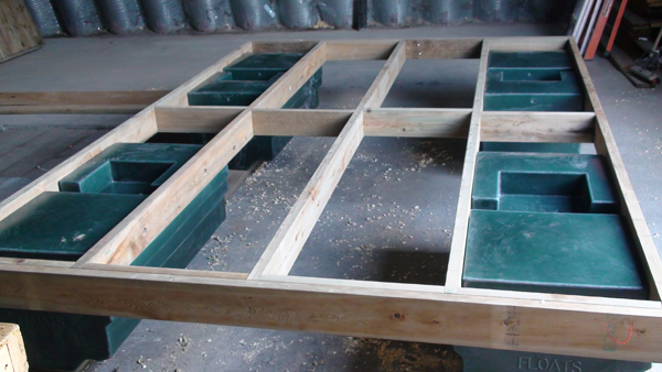 A wooden frame encasing dock construction materials